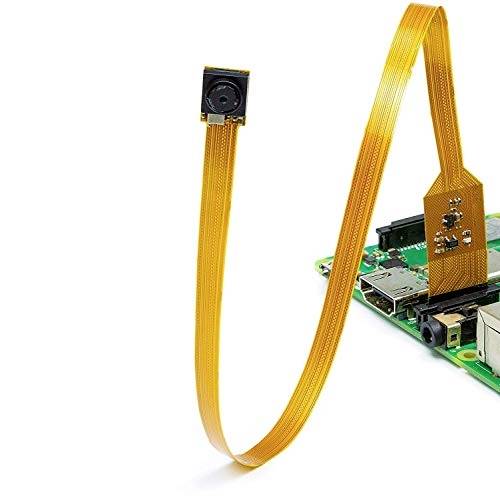 A small camera is connected to a flat ribbon cable that is linked to an electronic circuit.