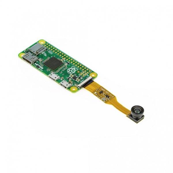 Small green circuit board with a camera, connected via a flexible ribbon cable. Contains electronics and connectors.