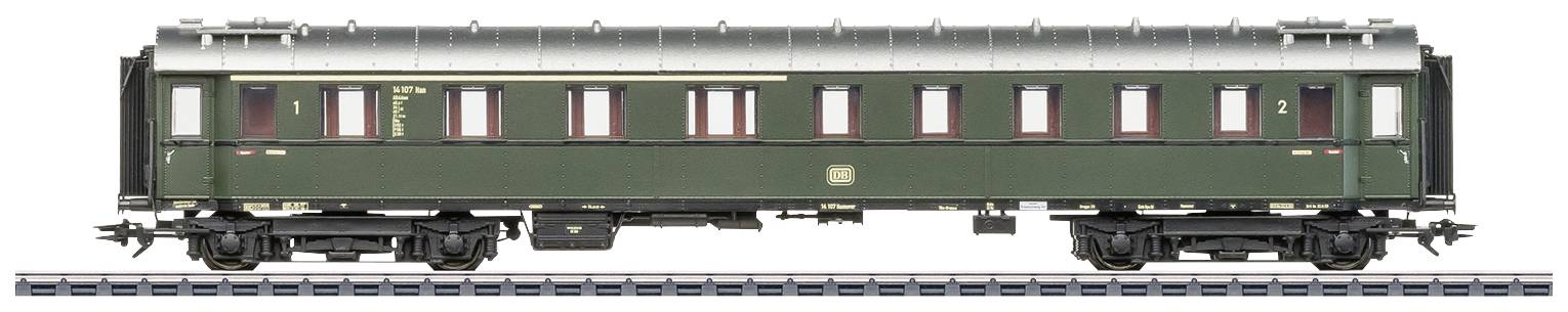 Green historical railway passenger carriage on tracks, shown in detailed view, with rows of windows and markings.