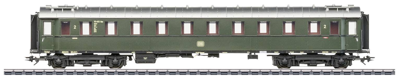 A green, historic railway carriage on tracks, with windows and the marking '2'.
