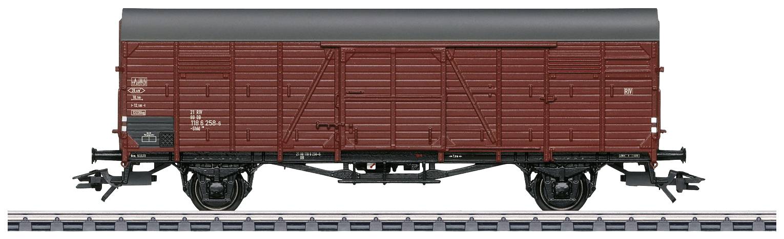 Goods wagon model in brown colour on a section of railway track, side view, with detailed accuracy showing doors and markings.