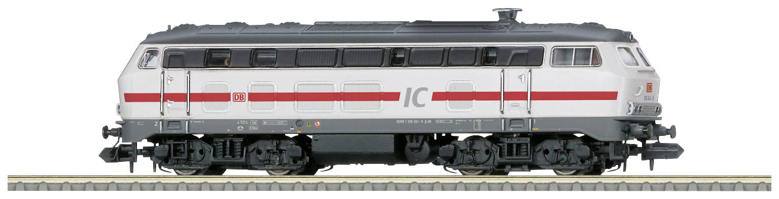 A white InterCity locomotive with a red stripe is standing on a track, side view.