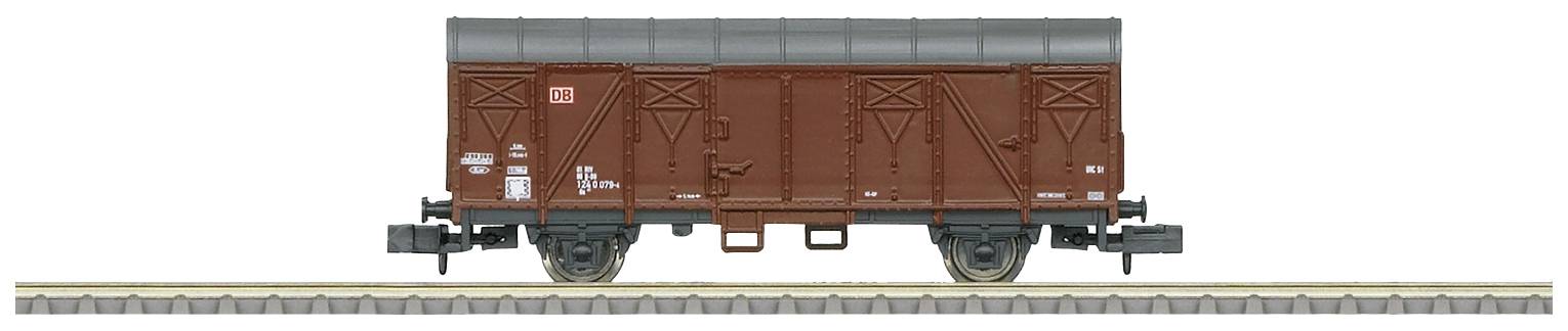 Brown goods wagon on track, side view. The wagon has a roof and technical markings on the side.