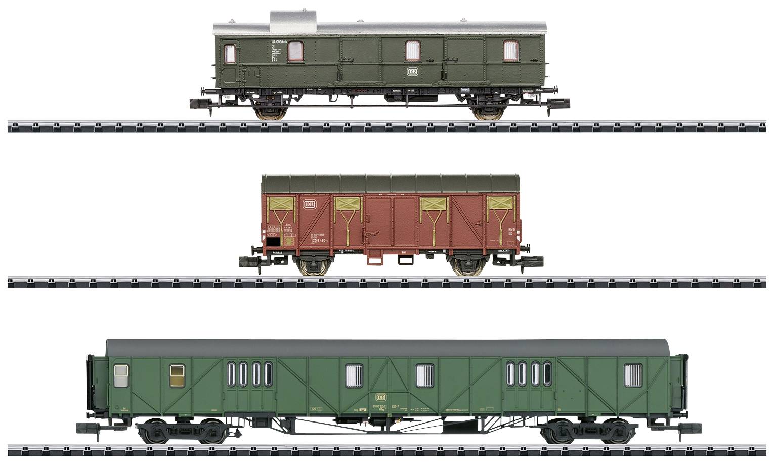 Three model railway carriages on tracks: At the top, a green luggage van, in the middle a red goods wagon, at the bottom a long green passenger carriage.