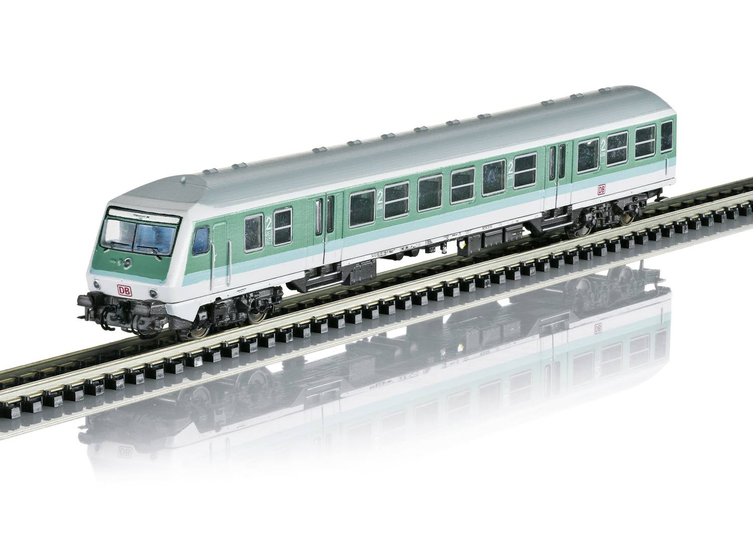 A green model train carriage on a rail, depicted as a toy railway.