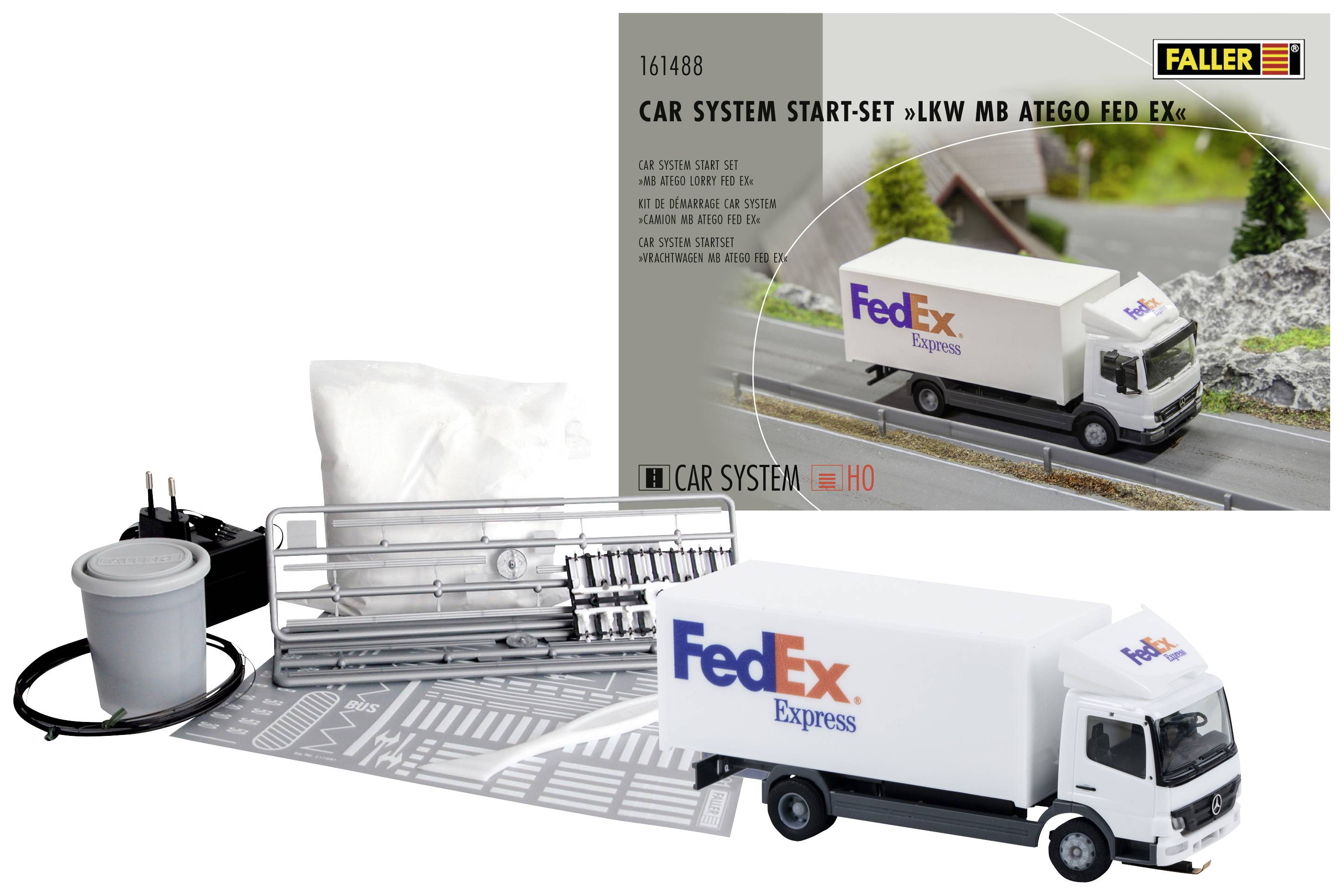 FedEx lorry model kit by Faller, complete with instructions and accessories, displayed against a background depicting a road scene.