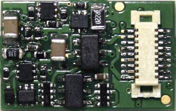 Electronic circuit board with various microchips and a white plug; shows complex circuit arrangement.