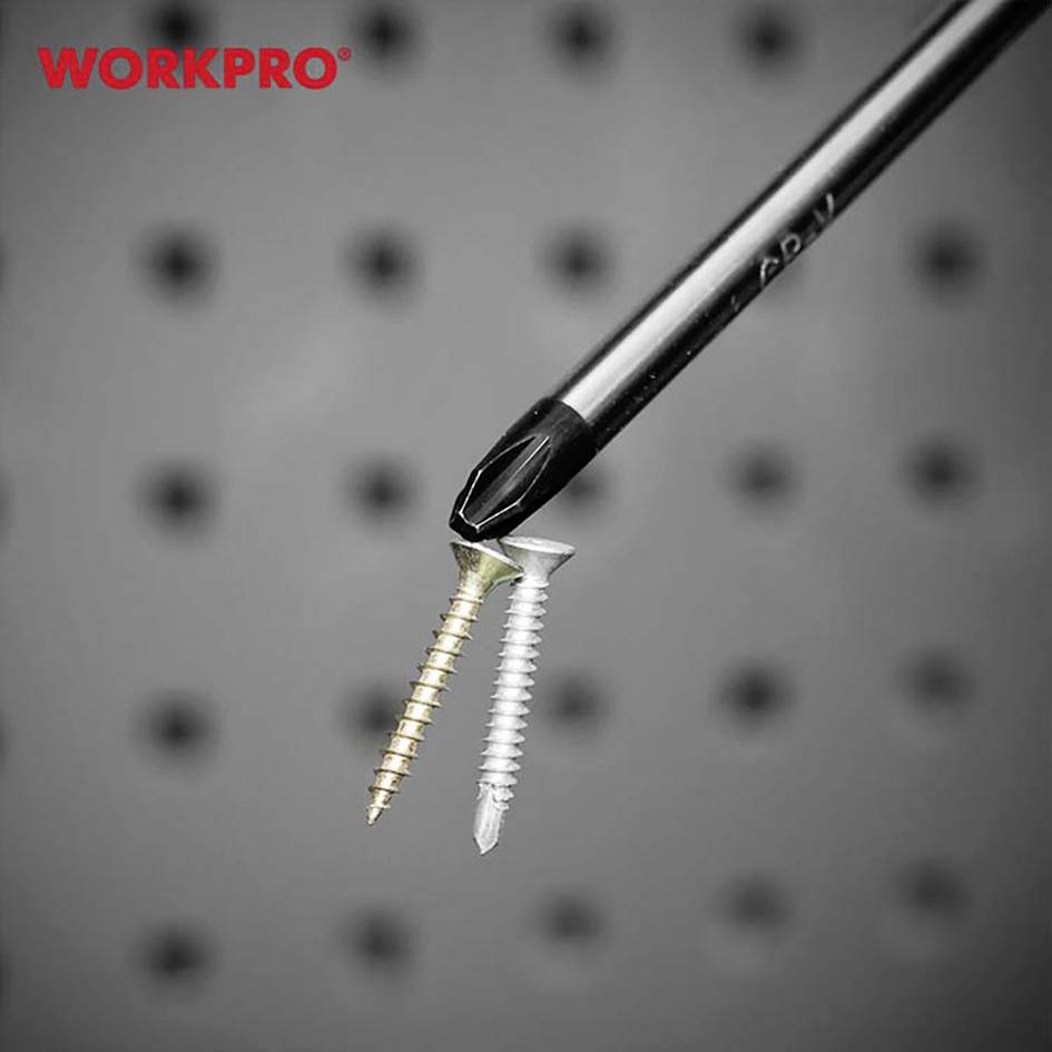 A screwdriver magnetically attracts two screws, one gold and one silver, against a blurred background.