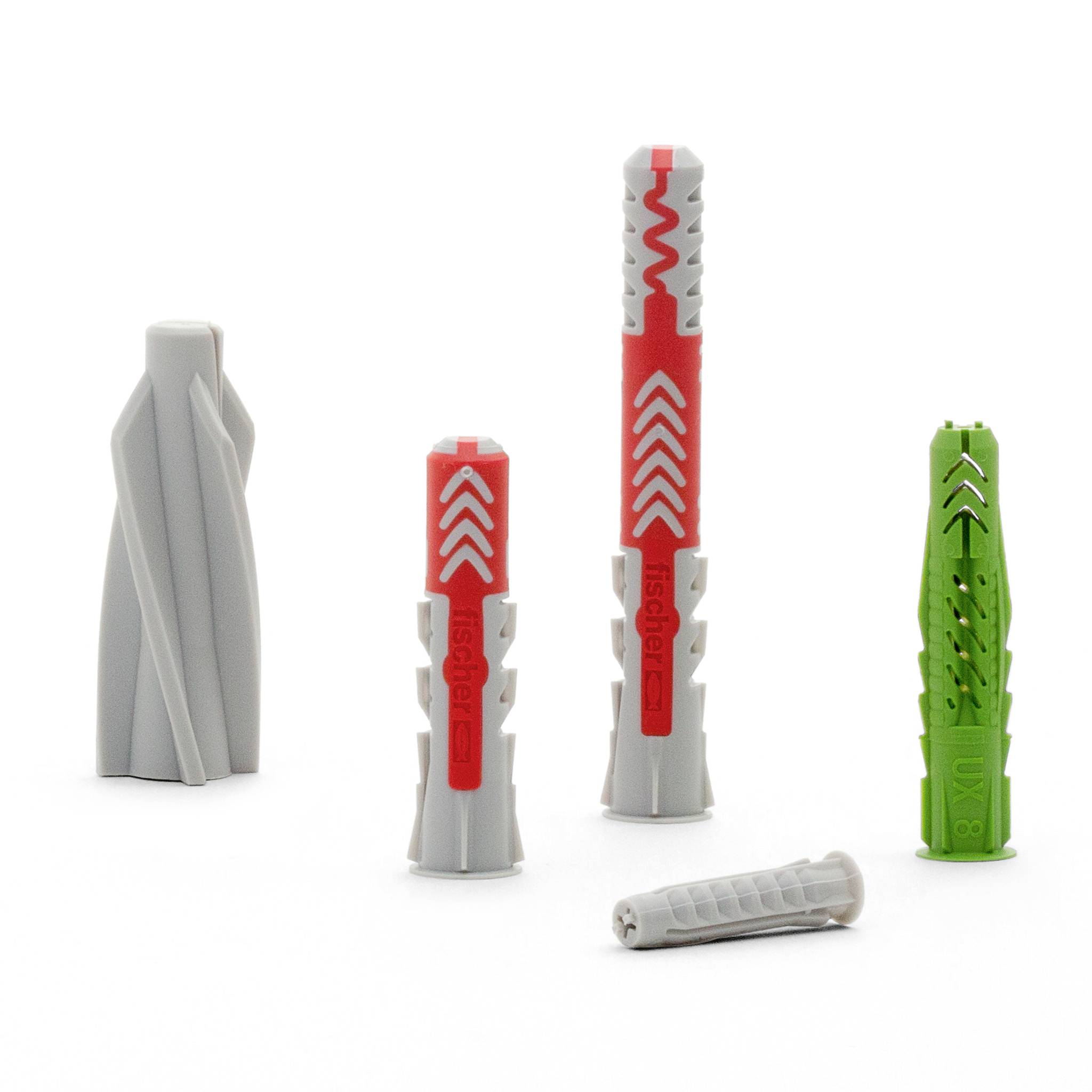 Various wall plugs in different sizes and colours, including grey, red and green models, stand upright on a white background.