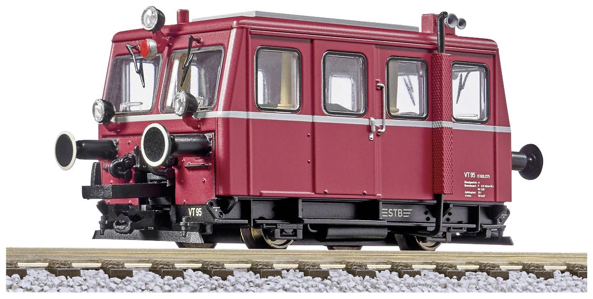 A red, vintage railbus on a railway track, viewed slightly from the front side. It has large headlamps and silver trim strips.