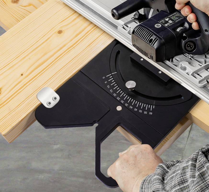 A person is using an electric handheld circular saw to cut wood. The saw is mounted on a metal sliding base with an angle gauge.