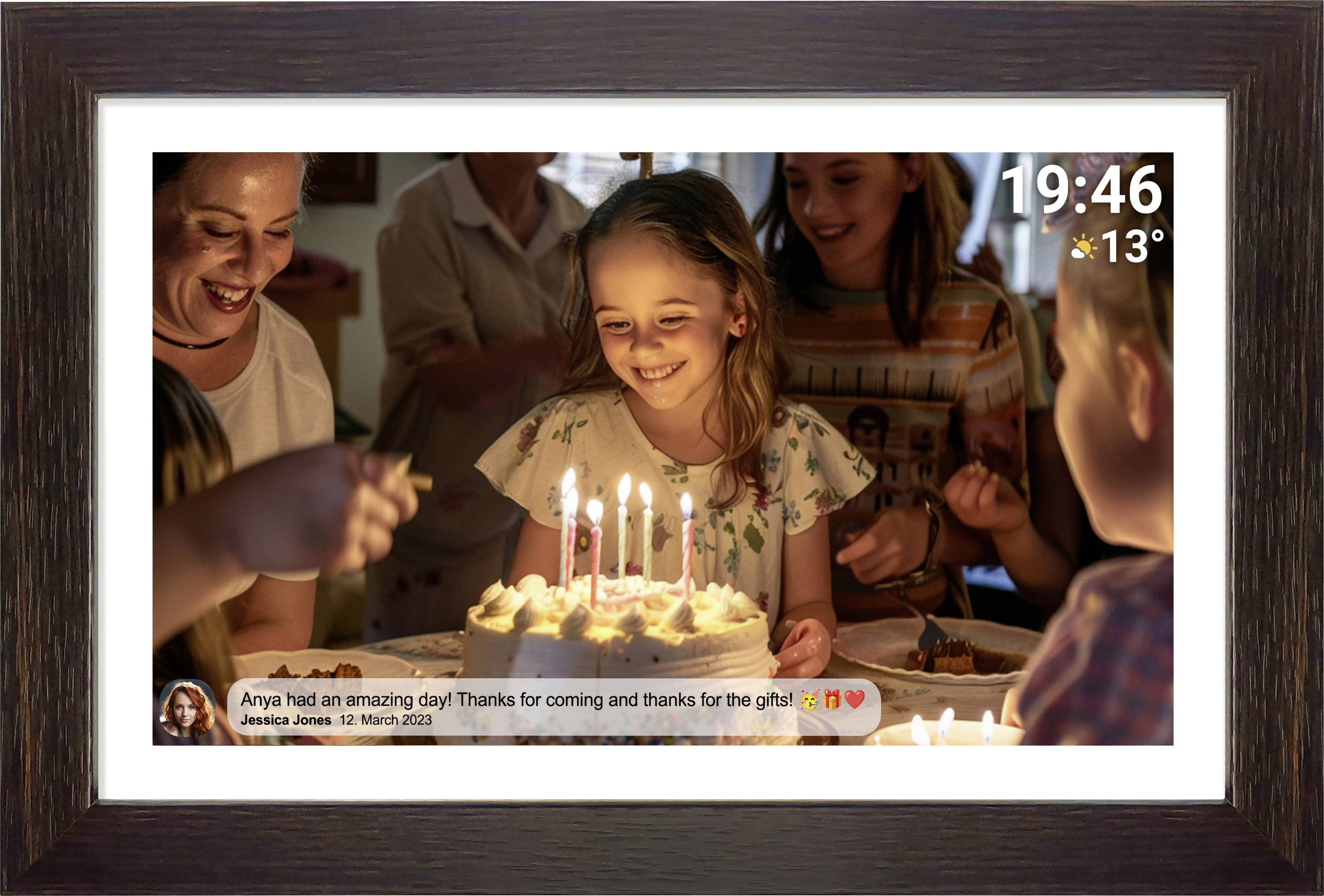 A girl smiles while sitting in front of a birthday cake with lit candles. Around her are celebrating friends.
