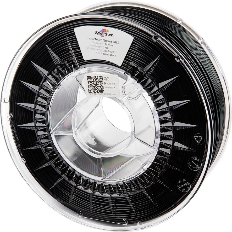 A black 3D printer filament reel with a label 'Spectrum Smart ABS', 1 kg, 1.75 mm. The label contains a QR code.