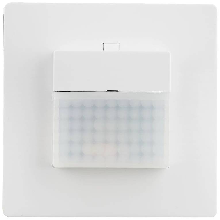 A white motion sensor on a wall for automatic lighting control.