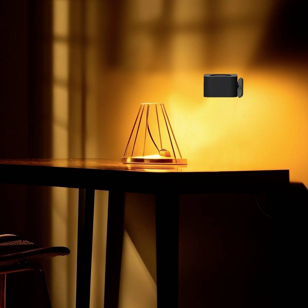 A table with a glowing, modern lamp illuminates the room in the darkness. A security camera is mounted on the wall.