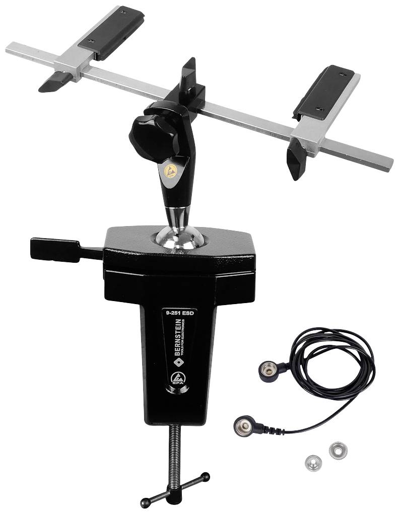 A black table vice with an adjustable arm and gripping tongs. Beside it lies a cable with two plugs and two washers.