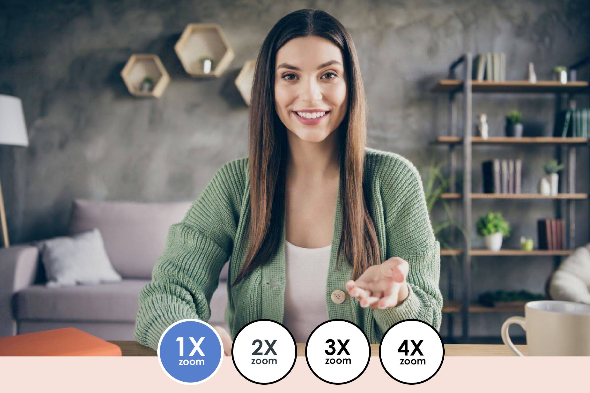 Woman in a green cardigan smiling at a desk, holding one hand open. Four zoom options highlighted at the bottom edge. Living room setting.