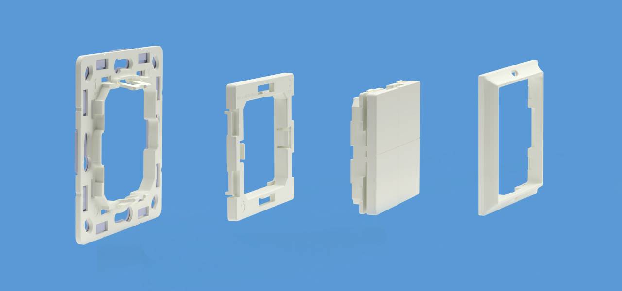 Four white plastic frames arranged side by side on a blue background. Each frame has different shapes and functions.