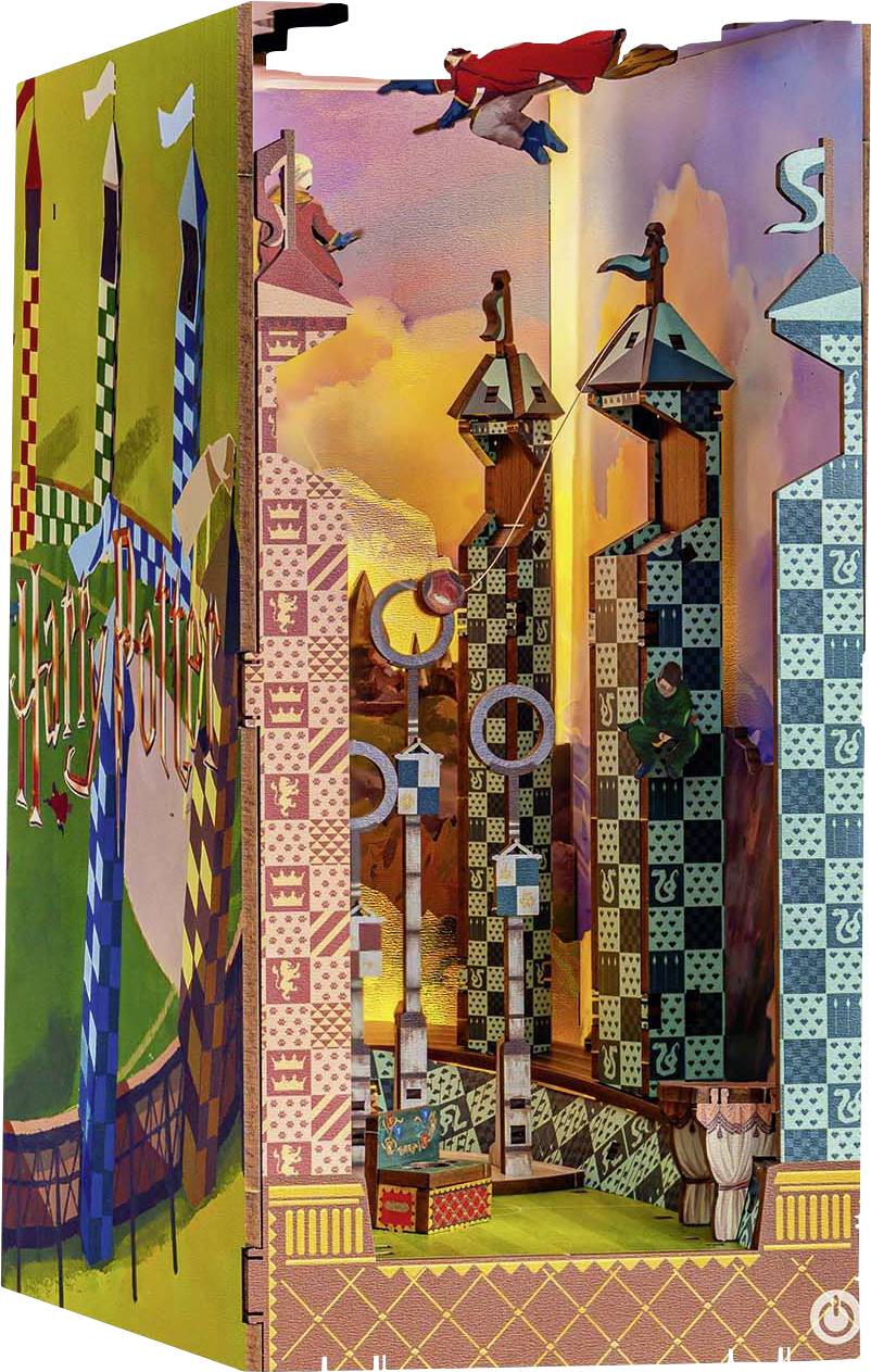 A vibrant, intricate pop-up book scene of a Quidditch match, featuring towers, goal hoops, and characters in mid-flight.