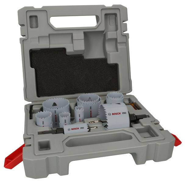 An open toolbox with various hole saws and accessories. The hole saws are arranged in slots, all within a grey plastic case.