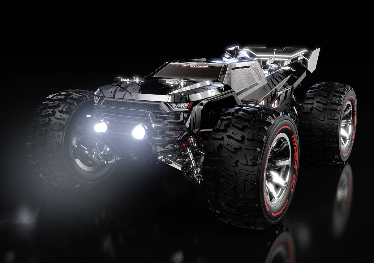 Black, futuristic remote-controlled car with large tyres and glowing headlamps against a dark background.
