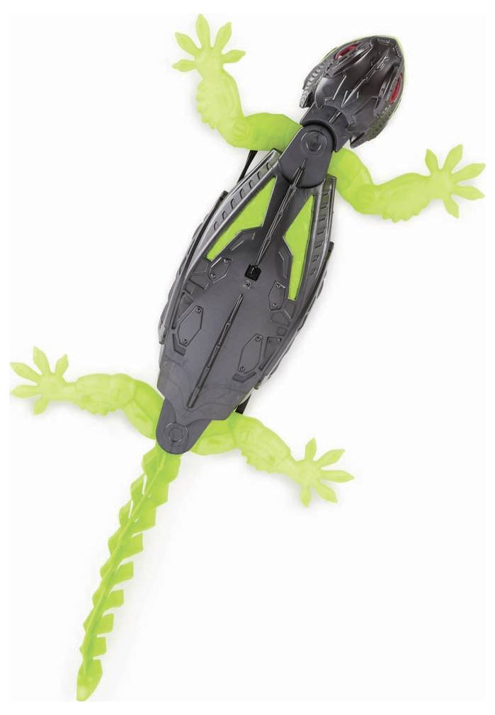A toy robot in the shape of a lizard with a green body and black details is lying on its back.