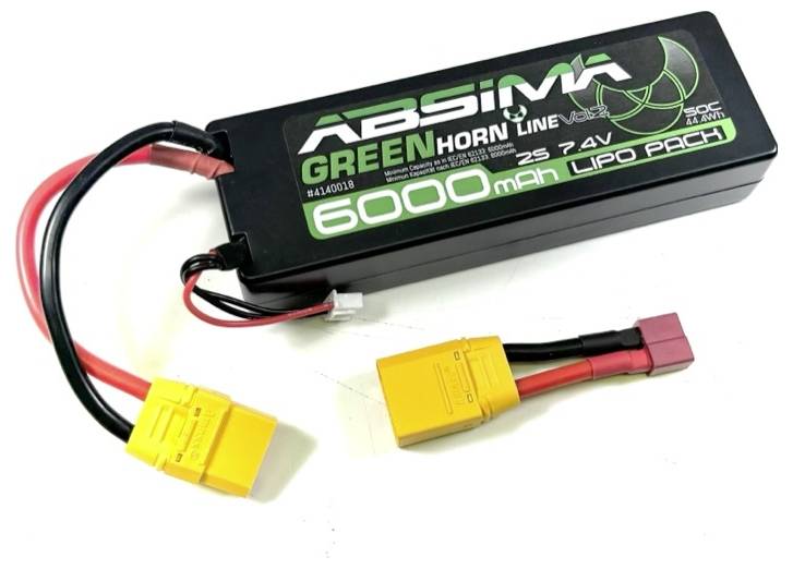 A lithium polymer battery marked 'Absima Green Hornet', 6000 mAh, 7.4 V. Two cables with yellow connectors are attached.