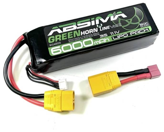 A black lithium-polymer battery with the inscription '6000mAh 35C 11.1V'. Two yellow connectors and another plug are visible.