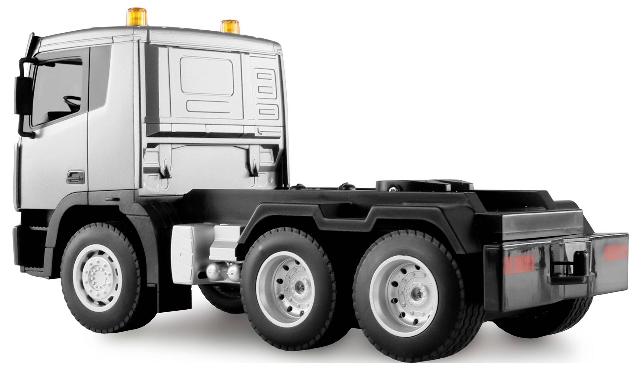 Silver lorry model photographed from the side without a trailer. Roof lights are switched on.
