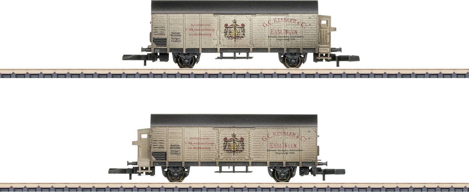 Two model freight wagons on tracks, one above the other. Both grey with red inscriptions and emblem. Track details visible.