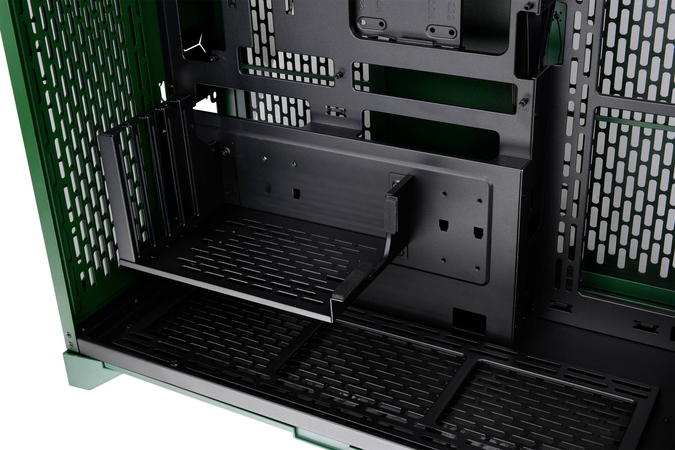 Internal view of a computer case with a green frame and black components; focus on a removable hard drive mounting bracket.