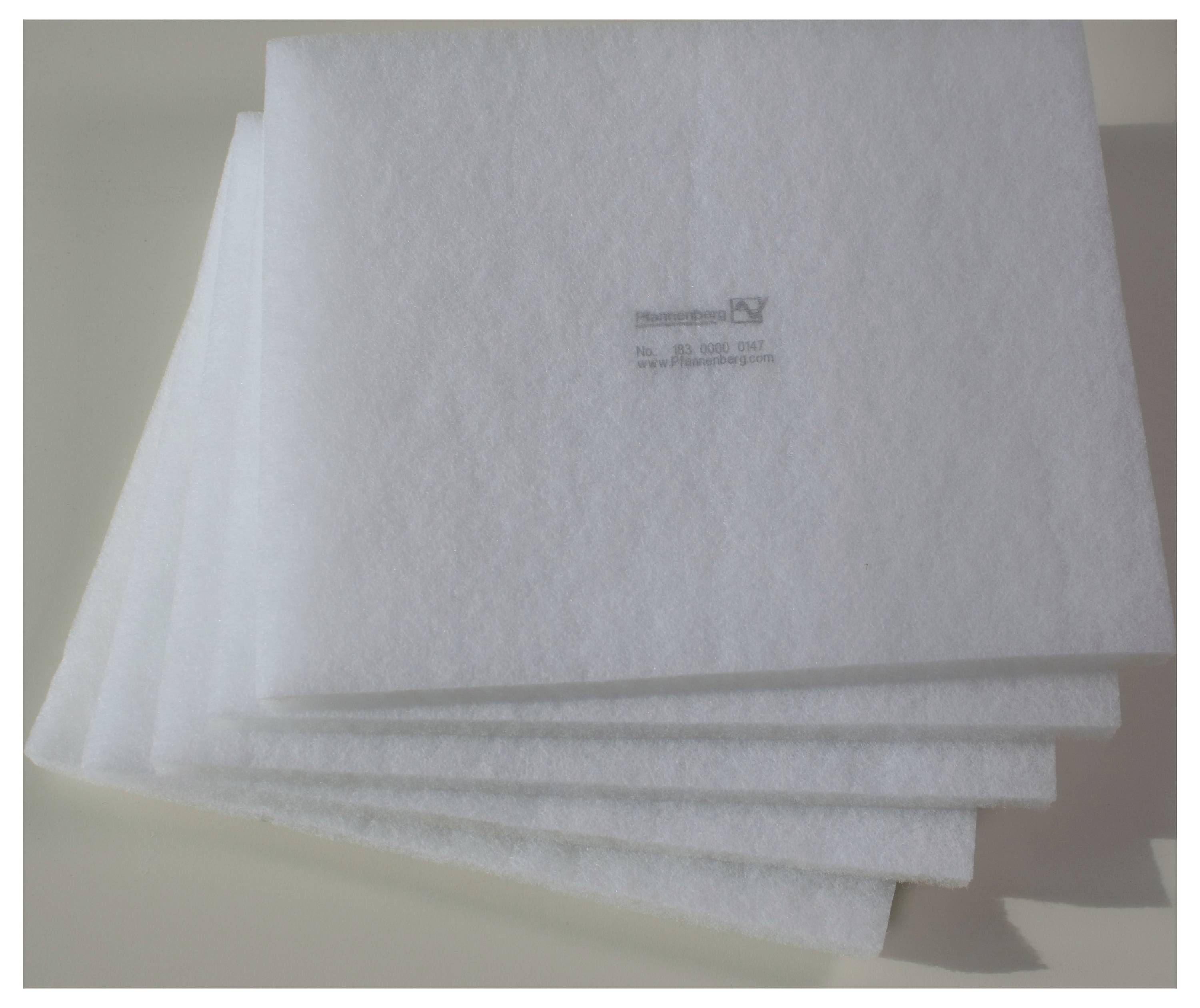 Several layers of white filter fleece sheets stacked.