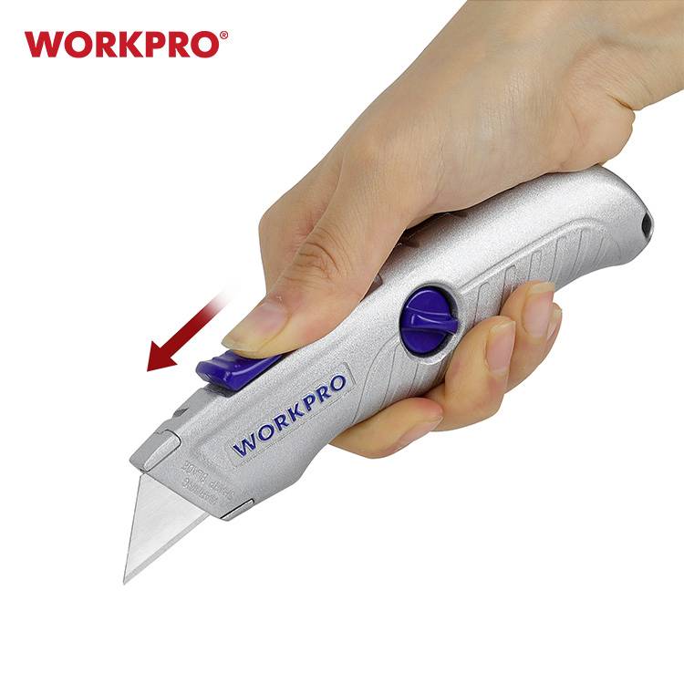 A hand is holding a silver retractable blade utility knife. A red arrow indicates the blade movement. Brand: 'WORKPRO'.