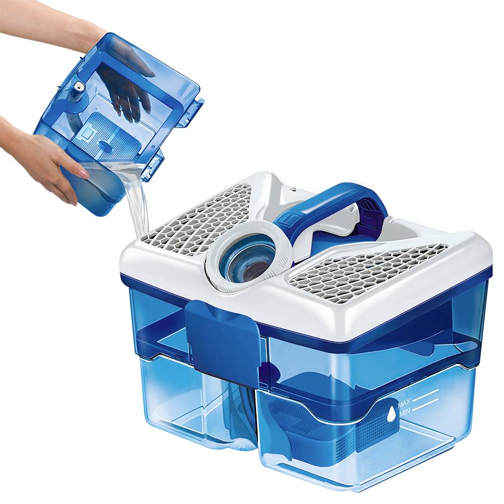 A person is pouring water into a blue water filter container with a carrying handle and a mesh lid, which is being prepared for use.