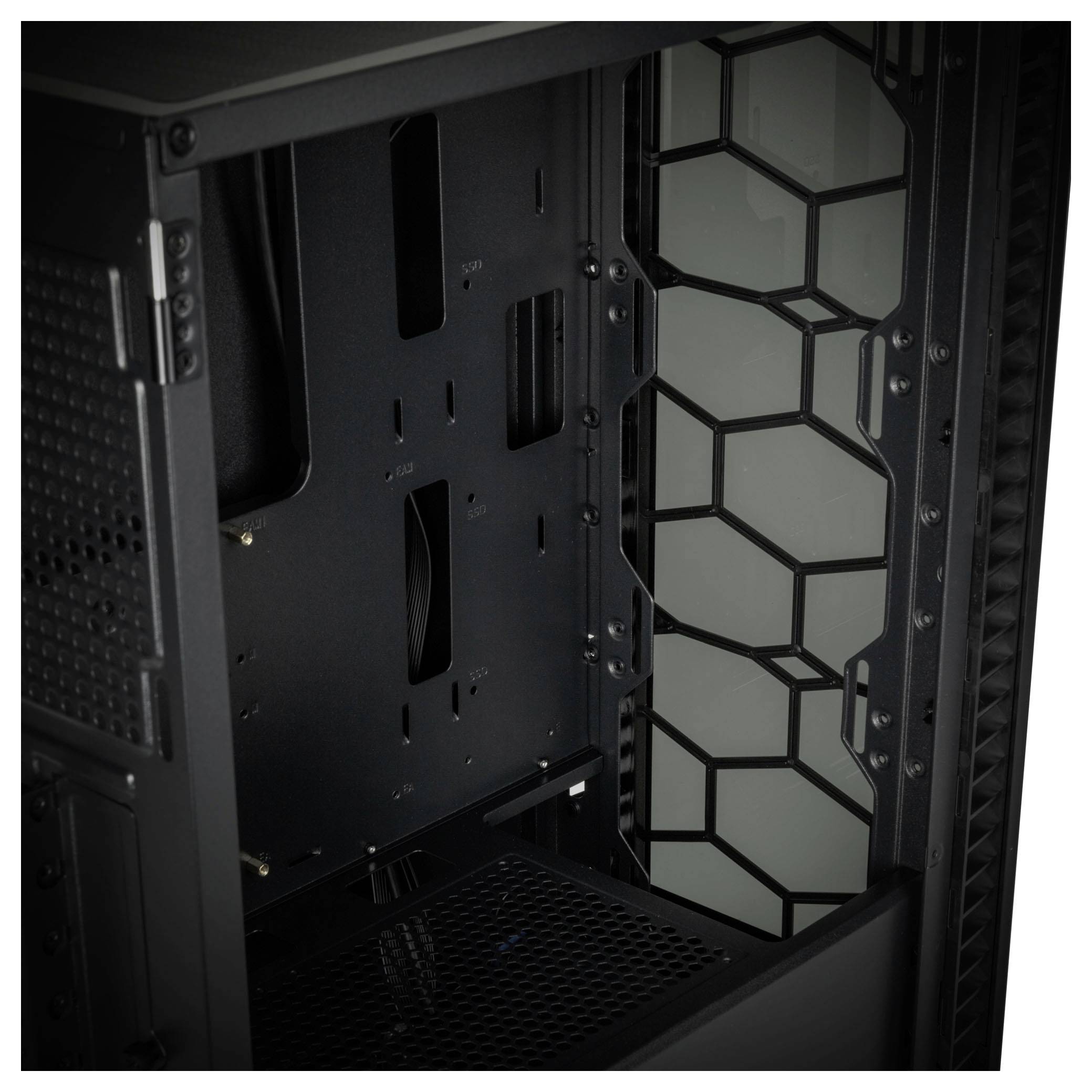 Interior side of a computer case with hexagonal ventilation slots, black frame and motherboard without components.