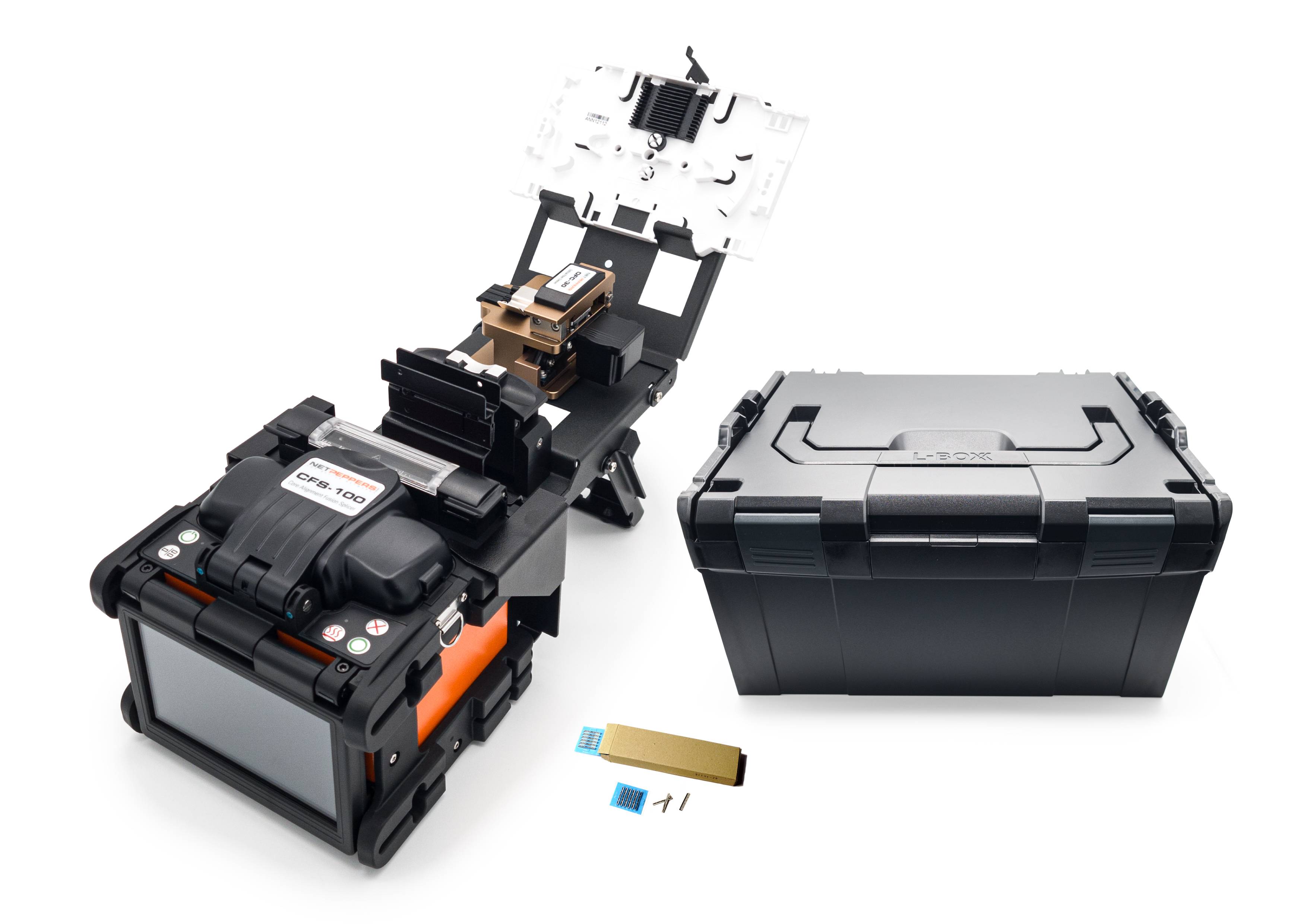 A fibre optic splicing machine with an open casing reveals its internal mechanisms. Beside it lies a black transport case.