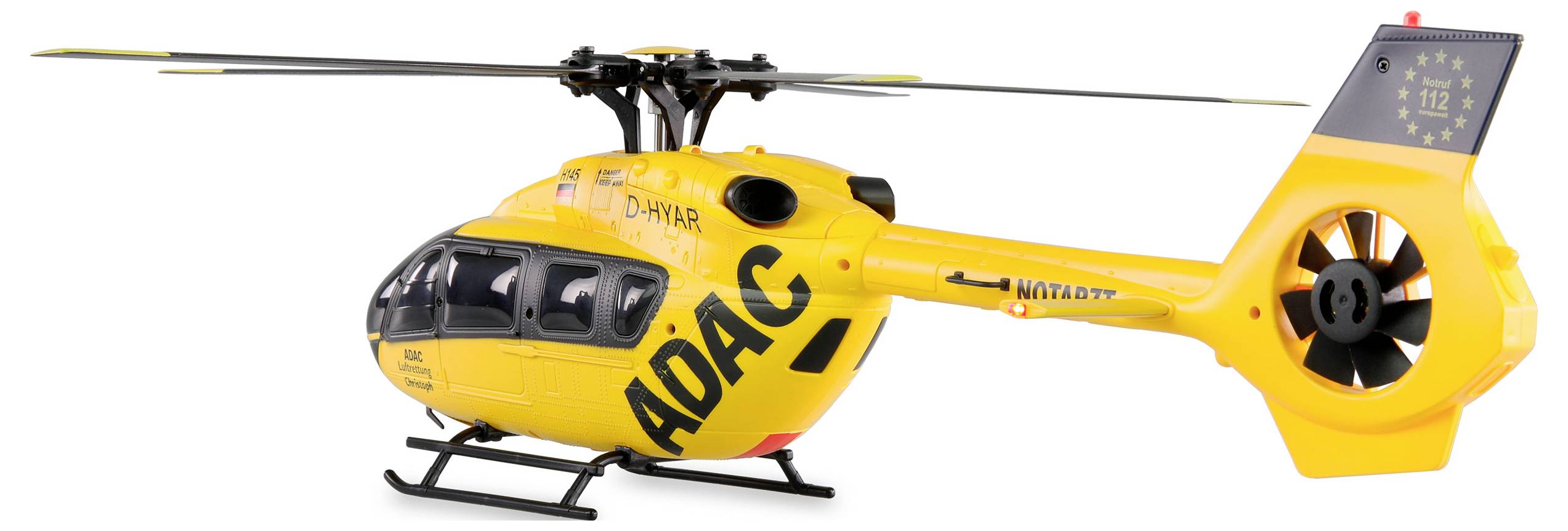 Yellow rescue helicopter with 'ADAC' written on the side, standing on the ground, serves emergencies and provides rapid medical assistance.