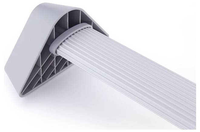 A grey plastic corner protector with a ribbed surface, used to protect wall edges or as an impact guard.