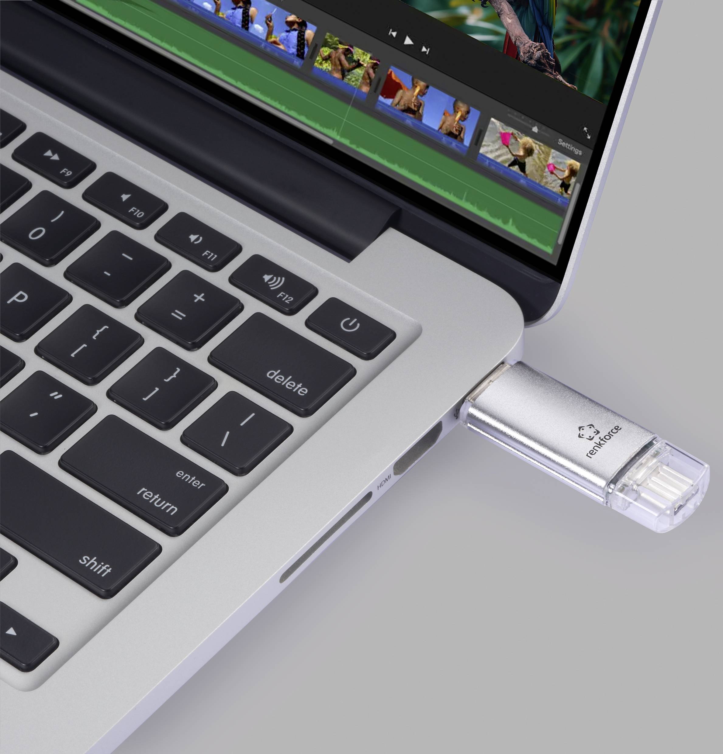 A laptop with a USB stick plugged in on the right-hand side, displaying an open video editing software on the screen.