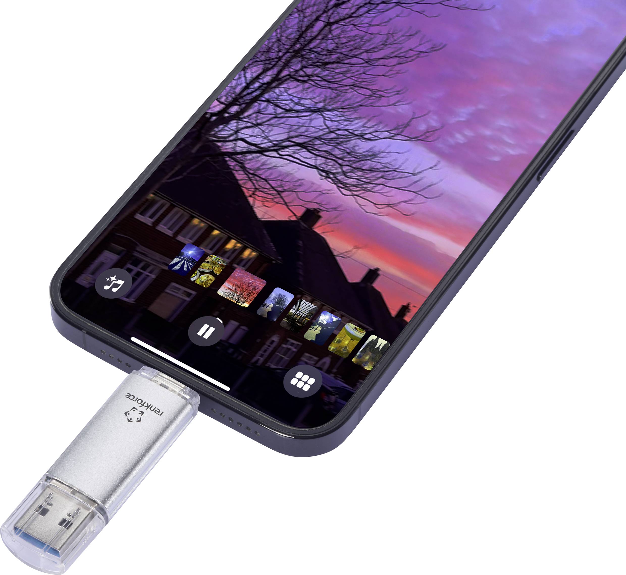 A smartphone with a USB stick connected displays photos of sunset over houses and trees on its screen.