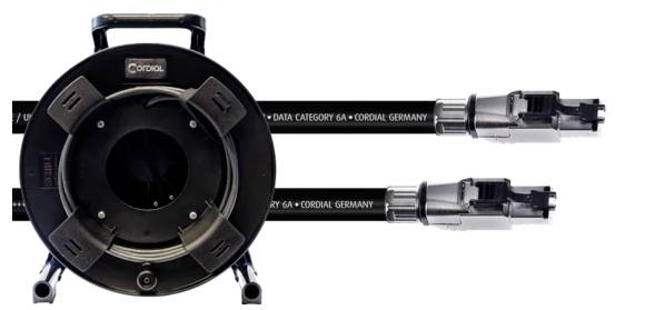A large cable drum winder with two Category 6A Ethernet cables from Cordial Germany, coiled and fitted with connectors.