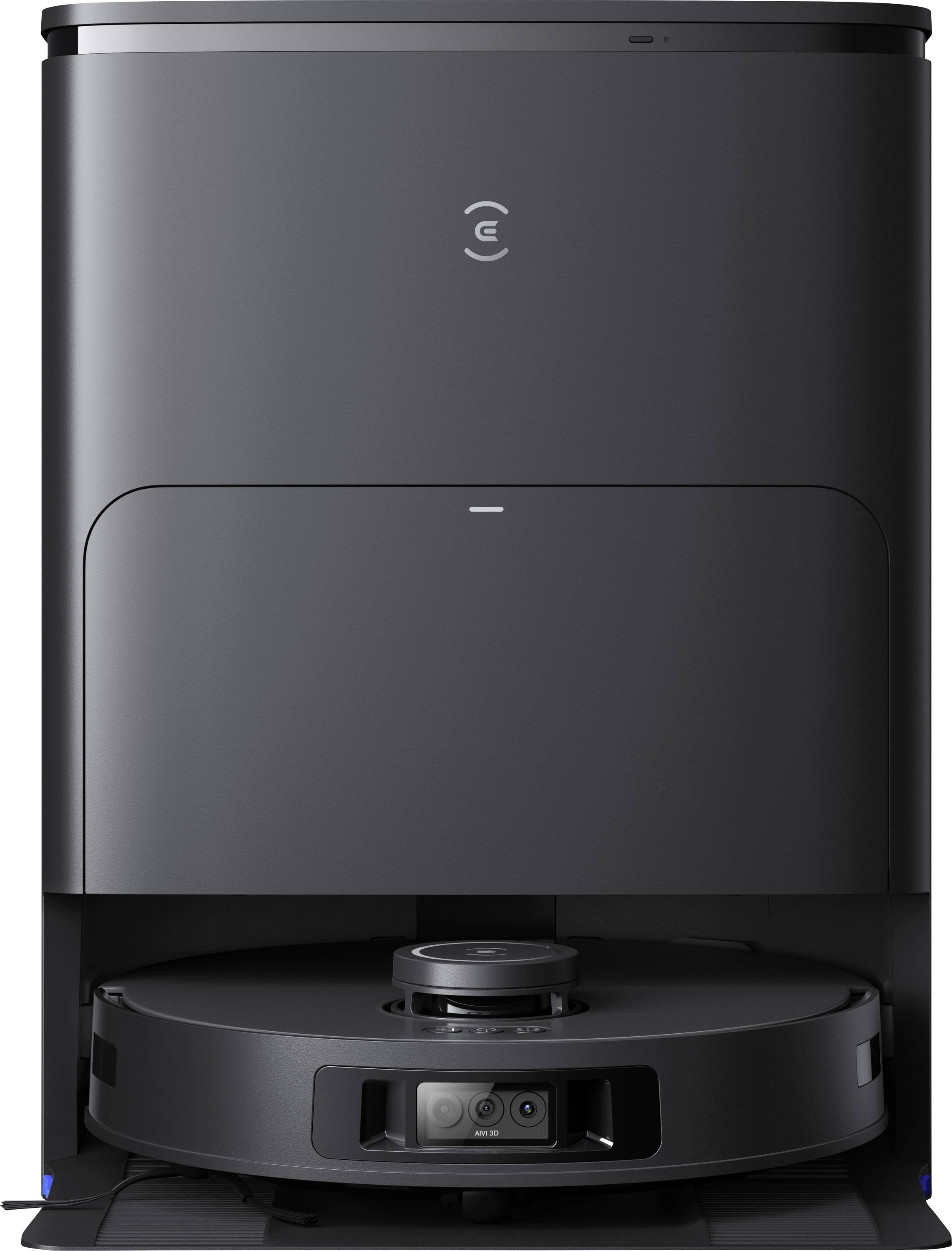 A black robotic vacuum cleaner in its charging station. The device has a simple, modern design with a smooth, rounded shape.