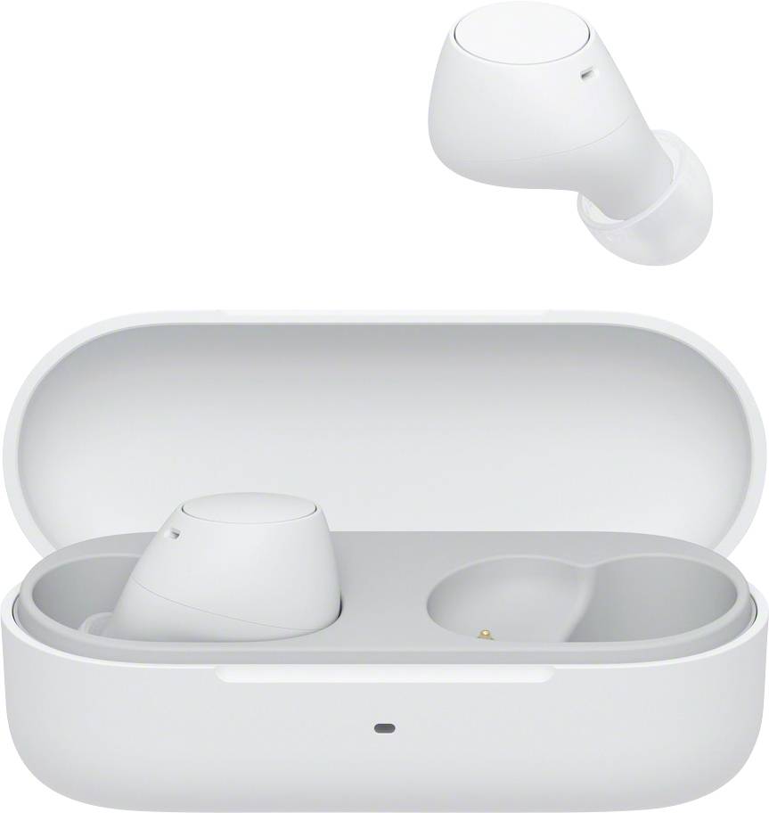 A white wireless earphone is lying outside its open charging case; another earphone is inserted in the case.