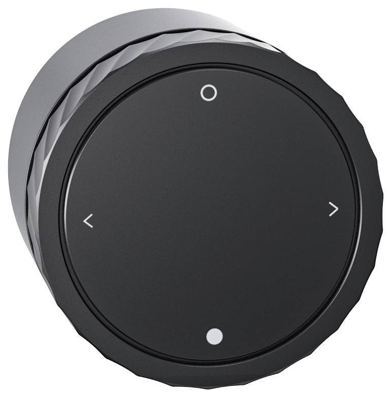 Black, circular control knob with directional arrows pointing left and right, and a circle and dot symbol.