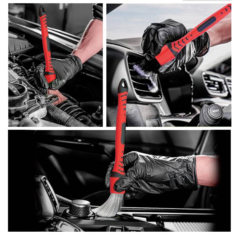 A small brush is being used by a person wearing black gloves to remove dust from an engine, a ventilation slot, and a gear shift knob.