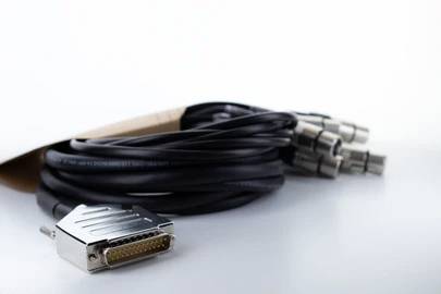 A bundle of black cables with a D-Sub connector on one end and several round metal plugs on the other end.