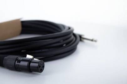 A long, black audio cable with an XLR connector on the left side and a 6.3 mm jack plug on the right side.