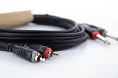 A bundle of black audio cables with various connectors, including a cinch plug. The cables are loosely coiled.
