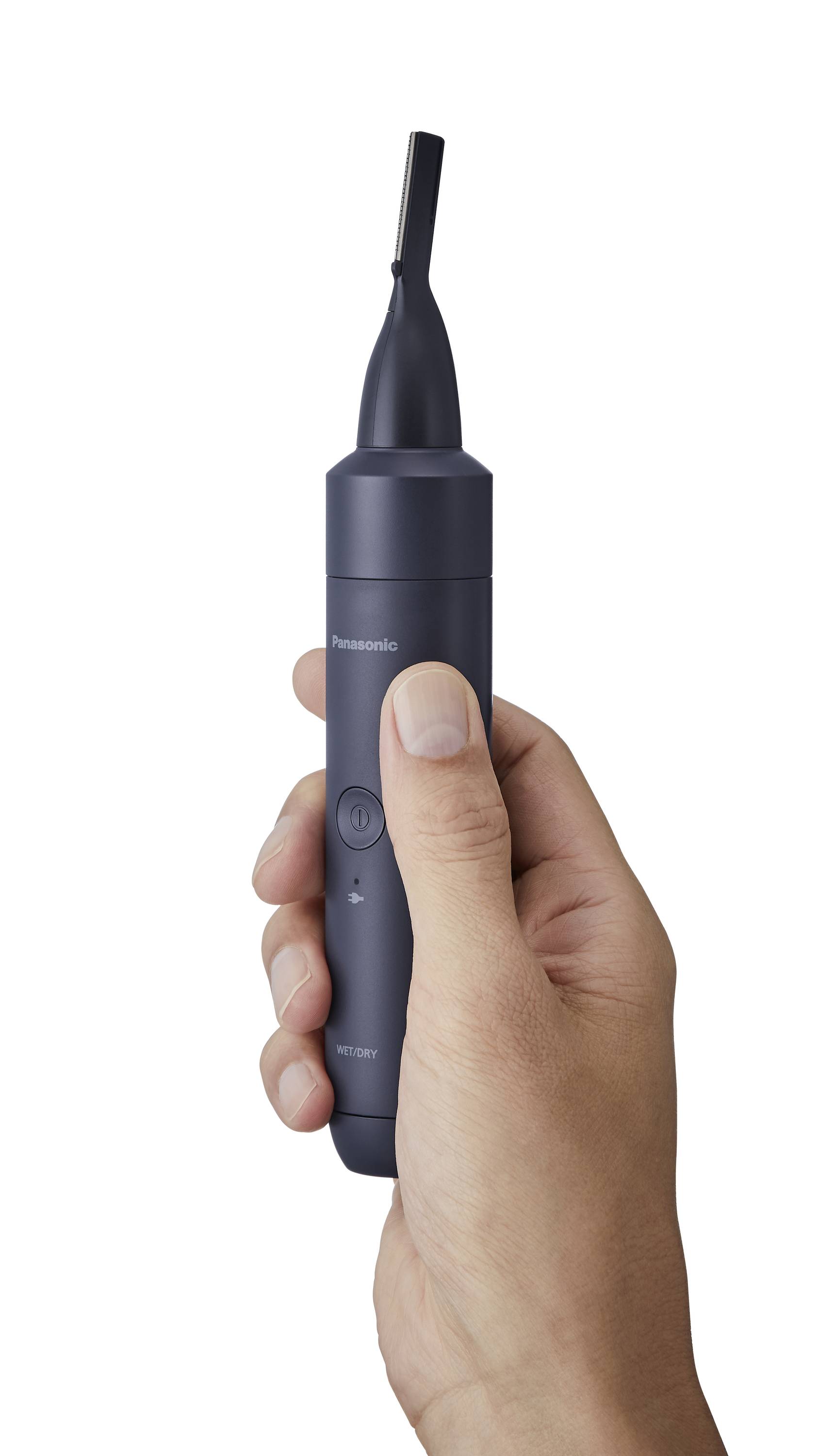 A hand is holding a black Panasonic electronic hair trimmer with a narrow tip, suitable for trimming details.