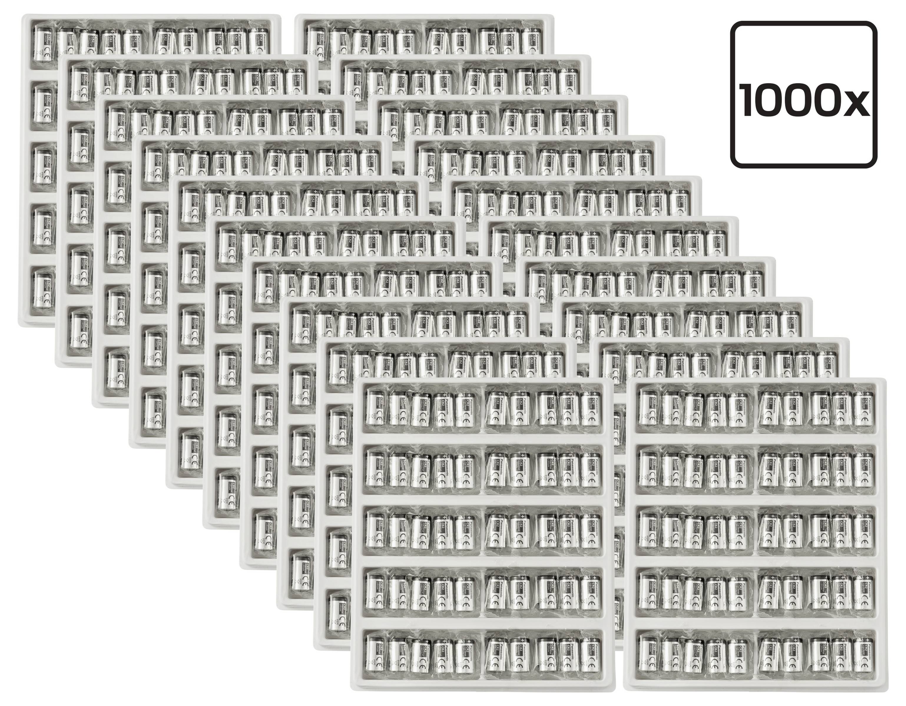 Stacked trays of small capsules, with a label reading '1000x' indicating a quantity of one thousand.